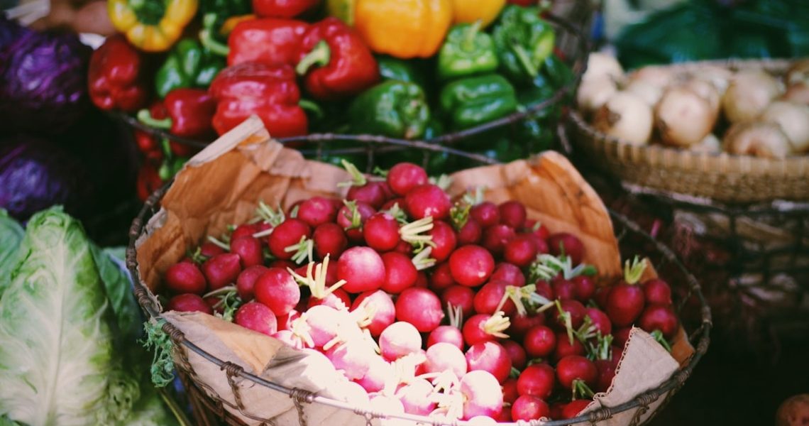 red and yellow bell peppers on white ceramic bowl